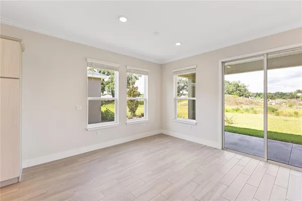 a room with stainless steel appliances kitchen island granite countertop a refrigerator and a stove top oven