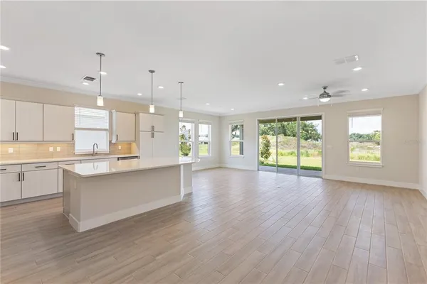 a living room with furniture wooden floor and a chandelier