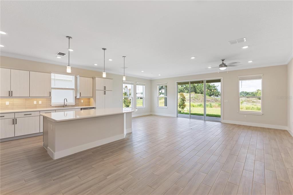 4473 Northwest 53rd Avenue Road Ocala, FL 34482 - Photo 15 of 40 a large kitchen with granite countertop a large counter top a sink stainless steel appliances and cabinets