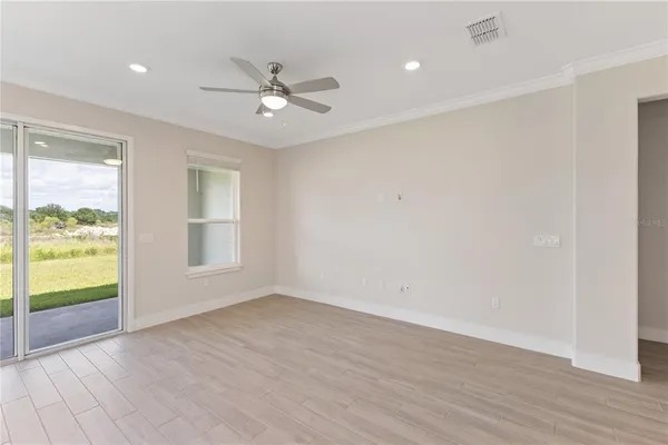 a living room with furniture and a floor to ceiling window