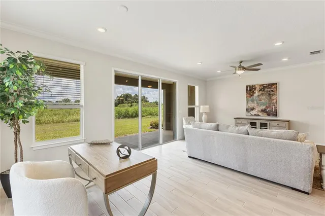 a living room with furniture and large windows