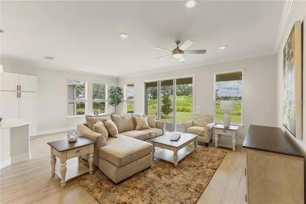 a living room with furniture and view of kitchen