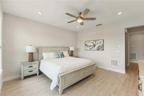 a bedroom with a large bed and a large window