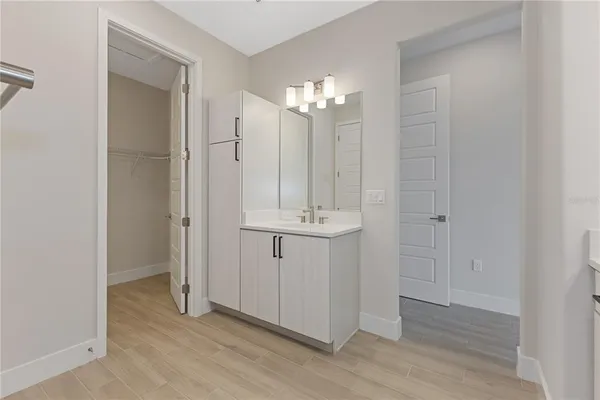 a bathroom with a sink vanity and mirror