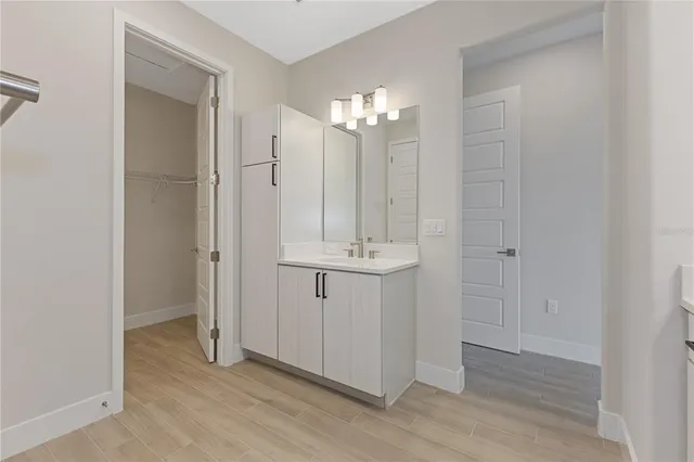 a bathroom with a sink vanity and mirror