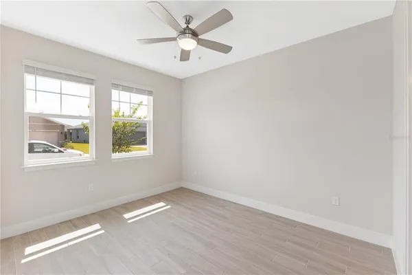 a view of empty room with wooden floor