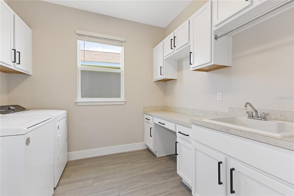 4473 Northwest 53rd Avenue Road Ocala, FL 34482 - Photo 39 of 40 a utility room with cabinets washer and dryer