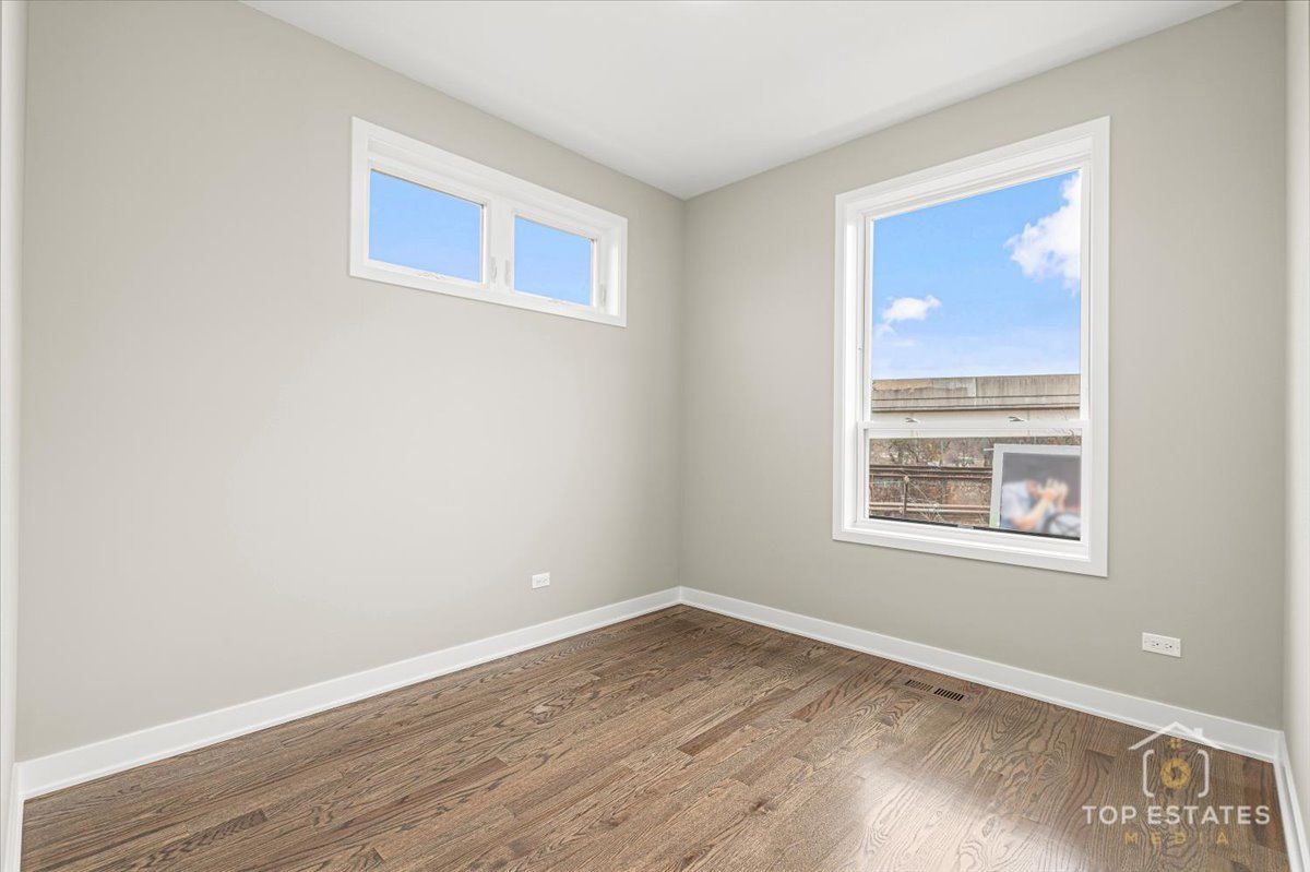3638 South Western Avenue, Unit F Chicago, IL 60632 - Photo 27 of 36 a view of an empty room with wooden floor and a window