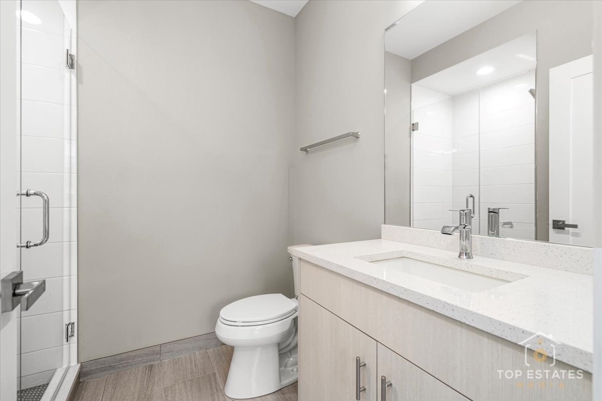 3638 South Western Avenue, Unit F Chicago, IL 60632 - Photo 9 of 36 a bathroom with a sink toilet and vanity
