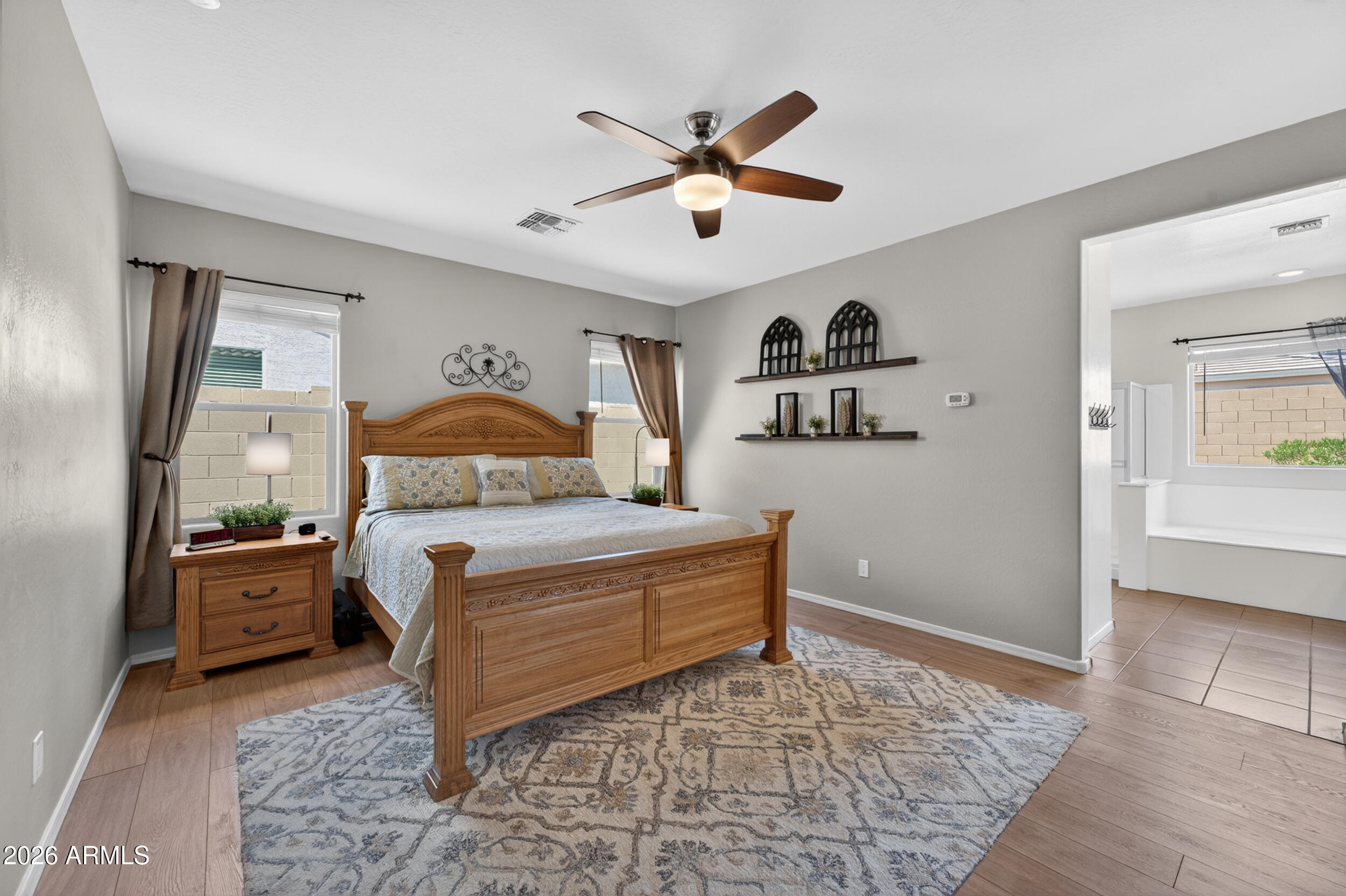 18612 West Mountain View Road Waddell, AZ 85355 - Photo 34 of 71 a bedroom with a bed and a ceiling fan