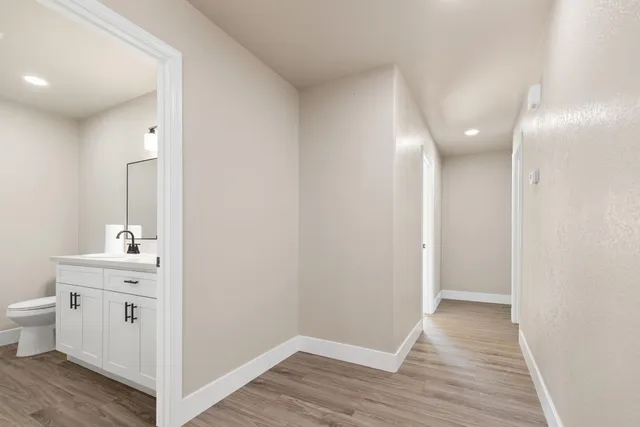 a view of a bathroom with a sink and a mirror