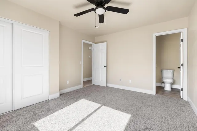 a view of empty room with wooden floor and window