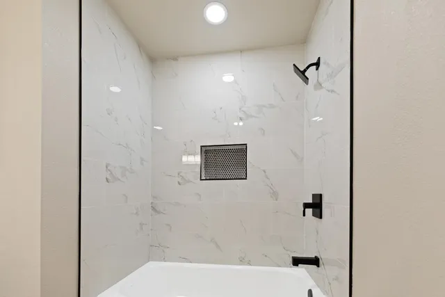 a bathroom with a shower and a toilet