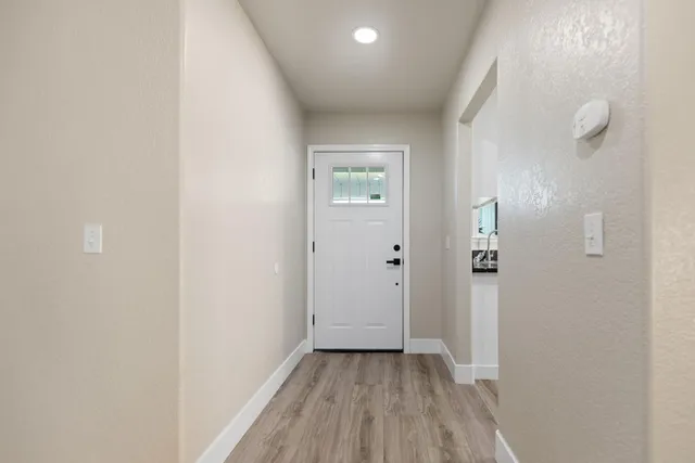 a view of a hallway with wooden floor