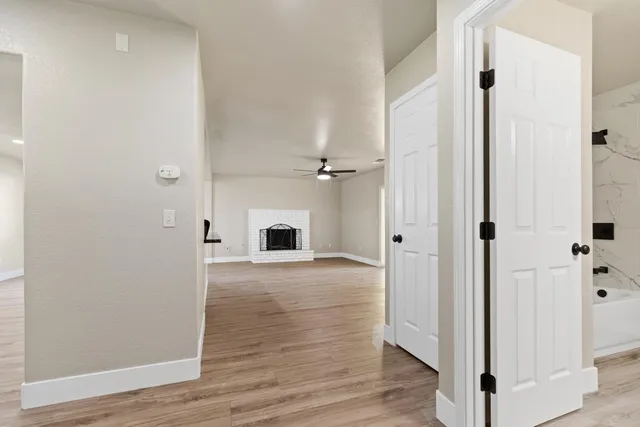 a view of an empty room with wooden floor
