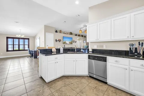 a kitchen with cabinets and window