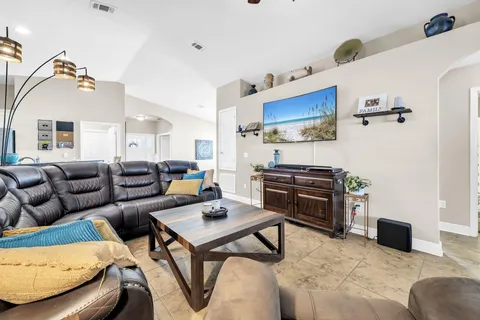a living room with furniture and a piano