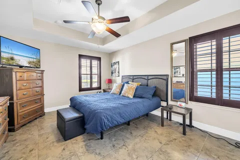 a bedroom with a bed and a chandelier