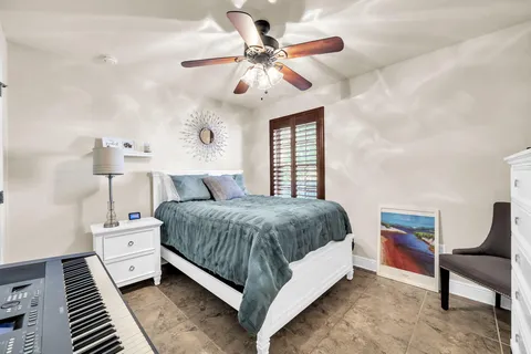 a spacious bedroom with a bed and a chandelier