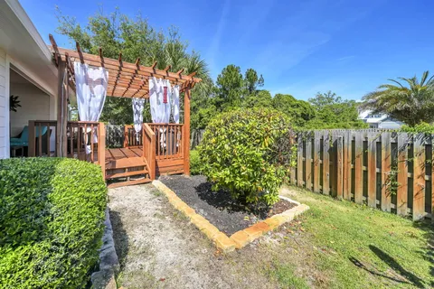 a view of house with backyard space and garden