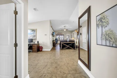 a view of a livingroom with furniture and a hallway