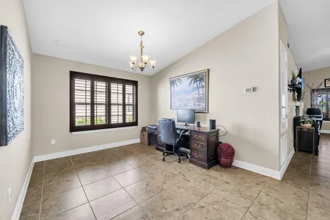 a view of a livingroom with workspace and a window
