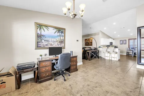 a view of a workspace with furniture and a chandelier
