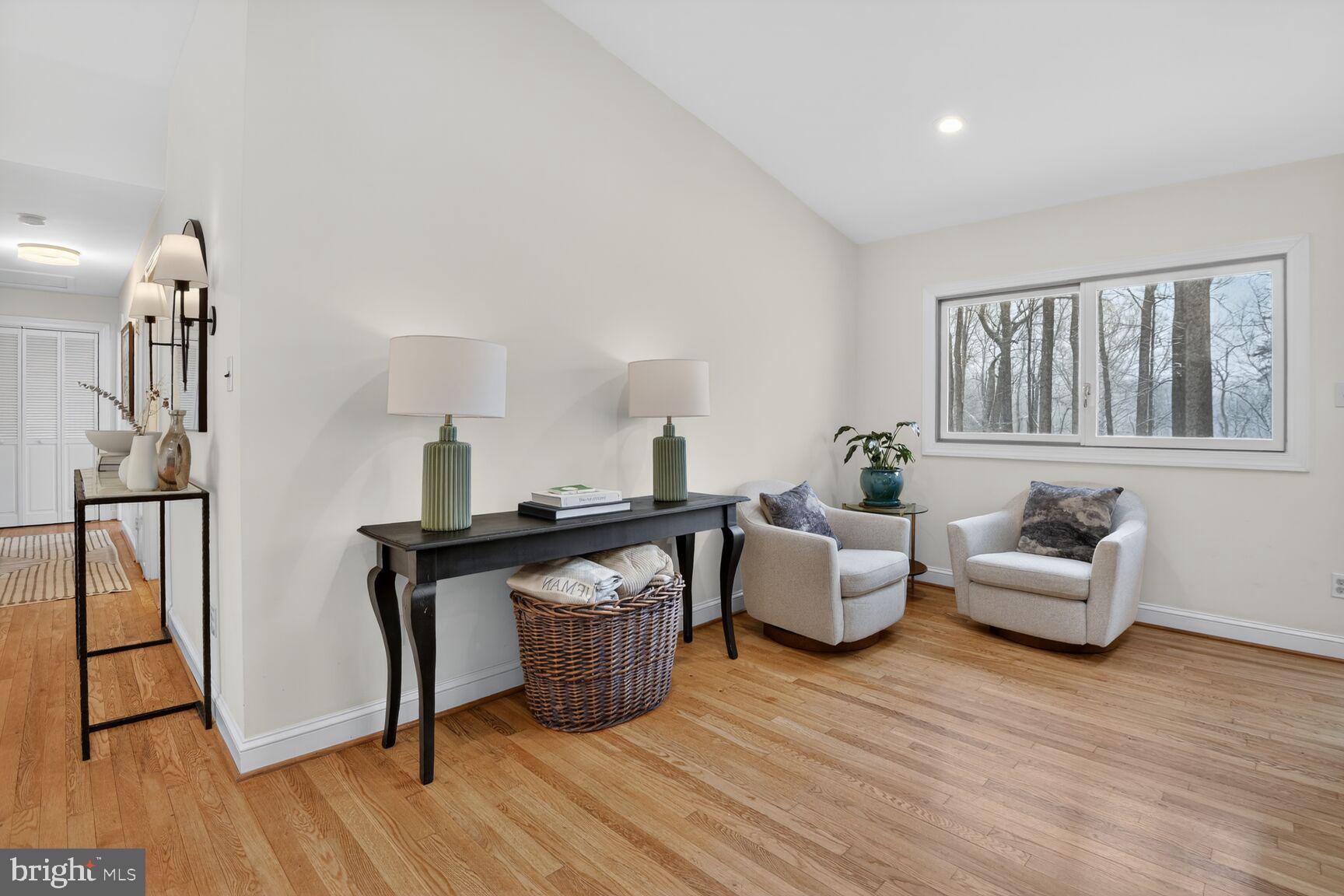 10209 Lloyd Road Potomac, MD 20854 - Photo 11 of 29 a living room with furniture a table and wooden floor