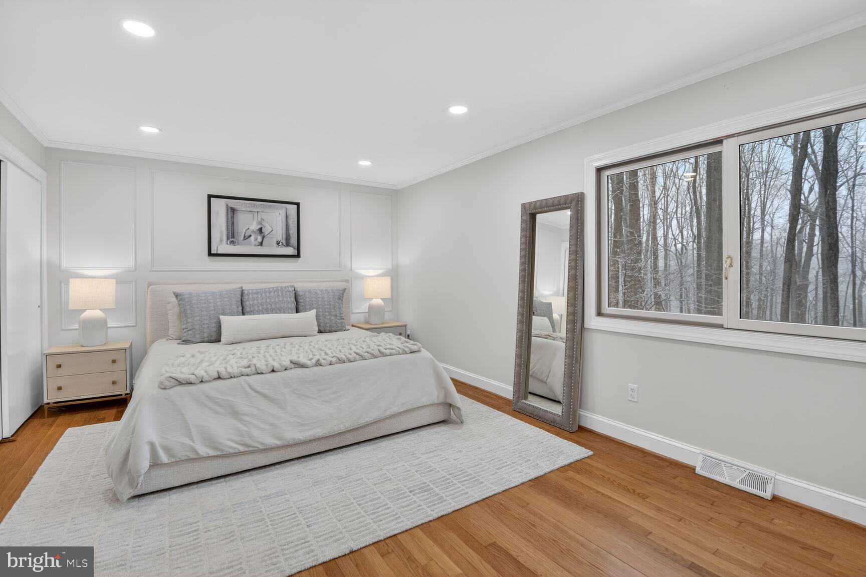 10209 Lloyd Road Potomac, MD 20854 - Photo 18 of 29 a spacious bedroom with a large bed and a window