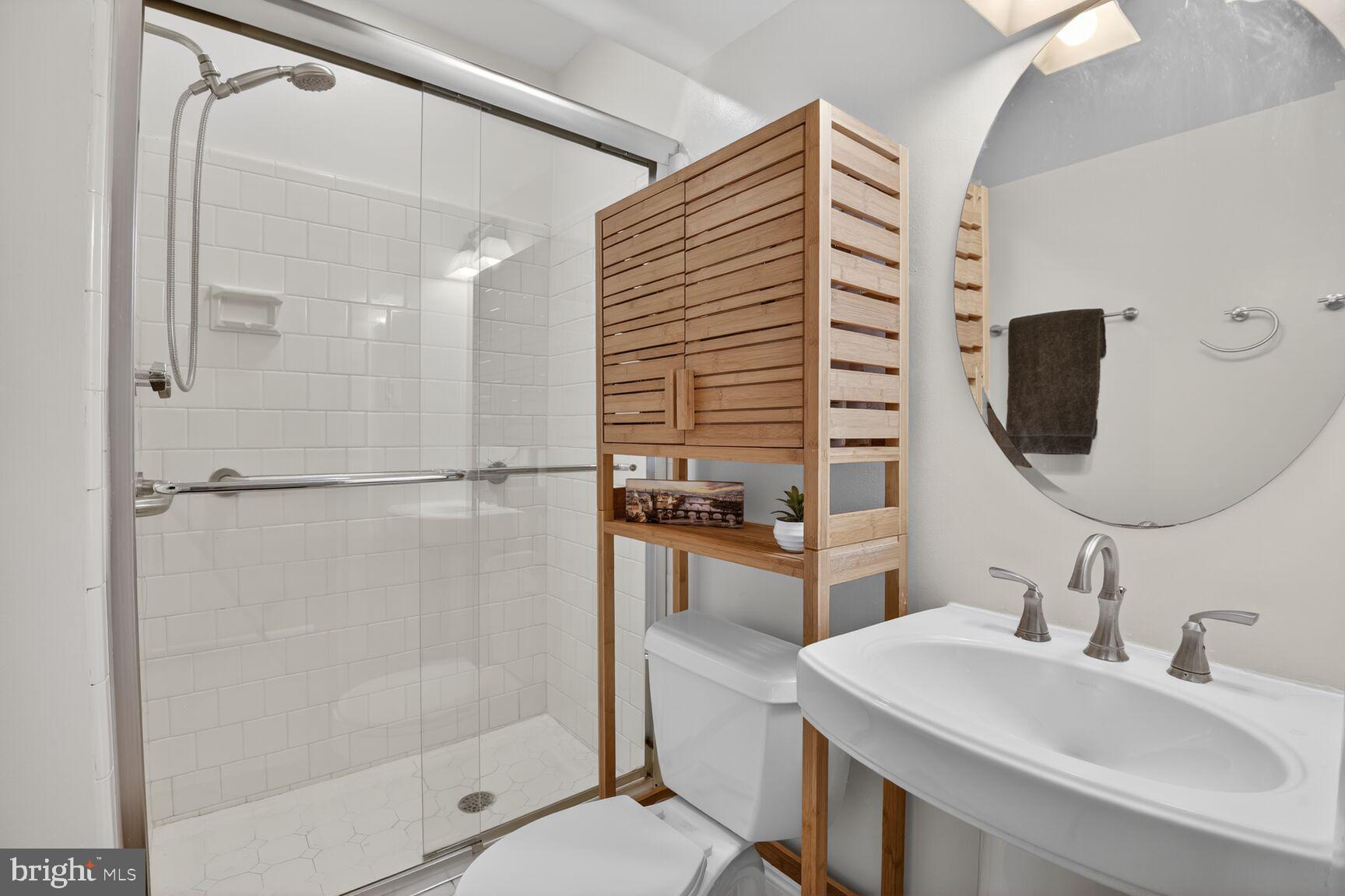 10209 Lloyd Road Potomac, MD 20854 - Photo 24 of 29 a bathroom with a sink toilet double vanity and shower