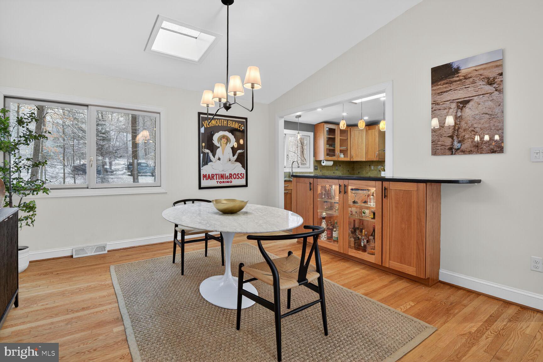 10209 Lloyd Road Potomac, MD 20854 - Photo 9 of 29 a view of a dining room with furniture a chandelier and wooden floor