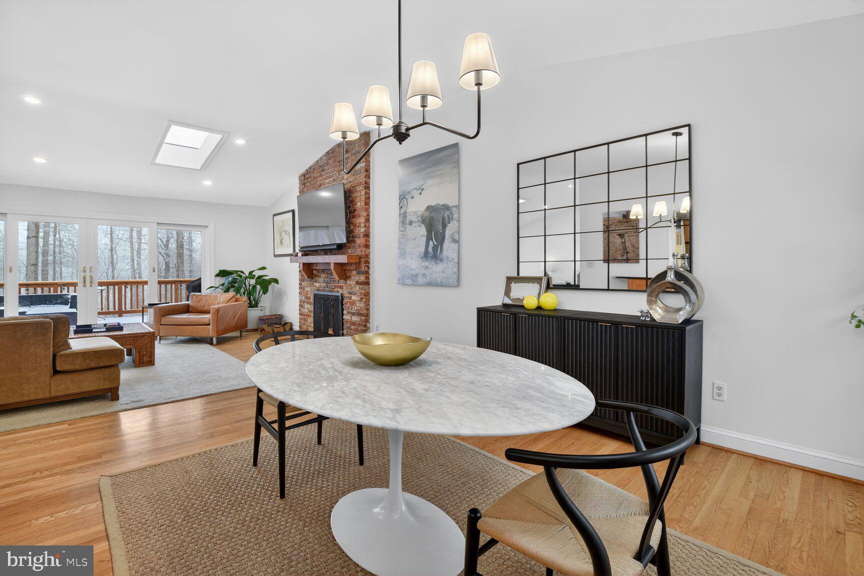 10209 Lloyd Road Potomac, MD 20854 - Photo 10 of 29 a living room with furniture a dining table and kitchen view