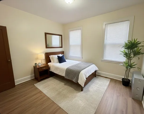 a bedroom with a bed and a potted plant