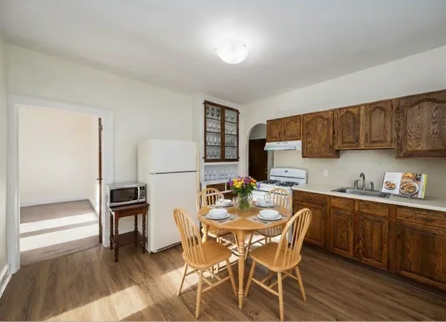 a dining room with furniture and wooden floor