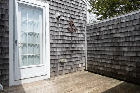 a view of a wooden door and a window