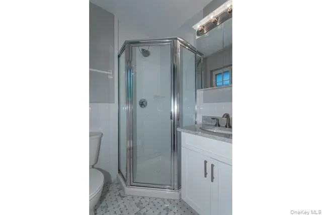 a bathroom with a granite countertop shower mirror and a sink
