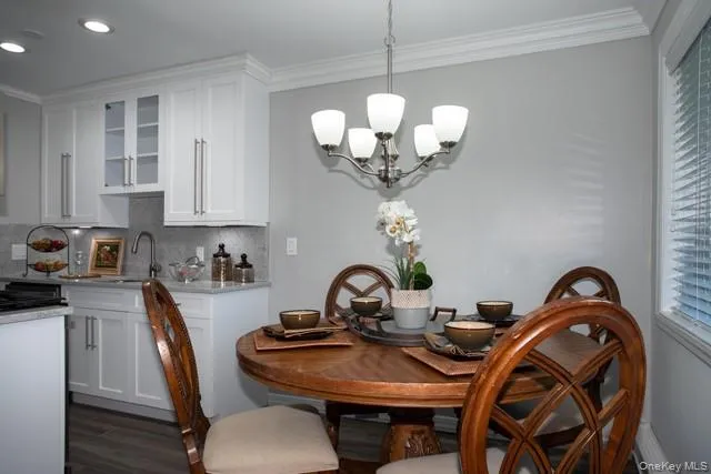 a view of a dining room with furniture and chandelier