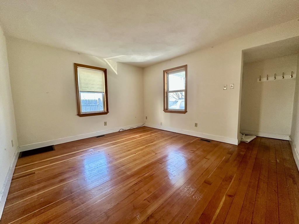 5 Rifle Court, Unit 5 Watertown, MA 02472 - Photo 3 of 14 a view of empty room with wooden floor and fan