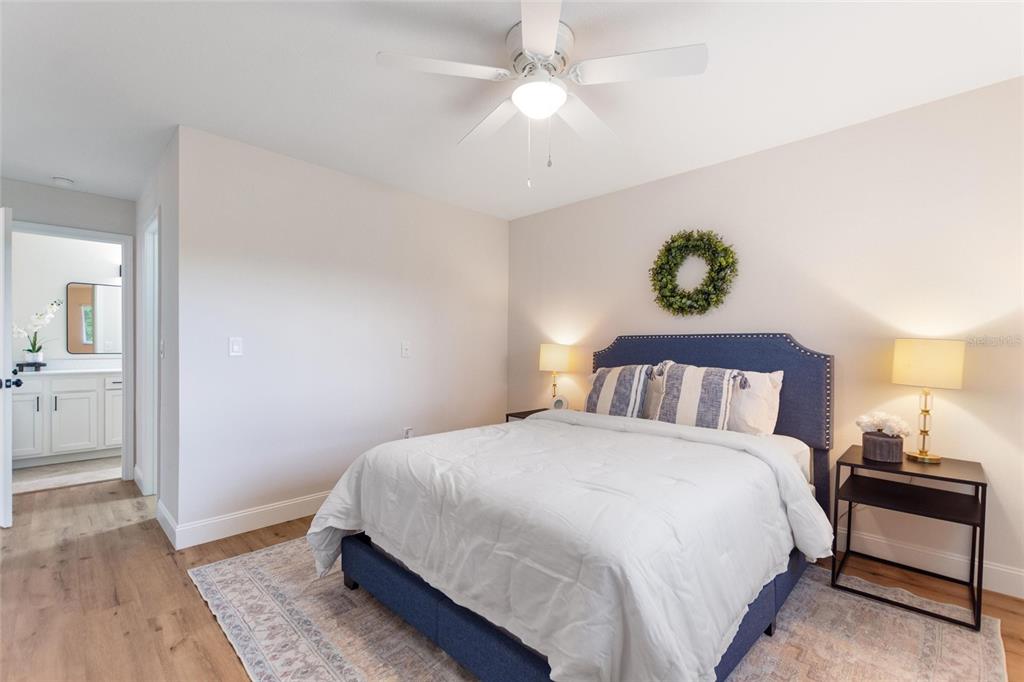 1950 Settlement Road, Unit 23 Venice, FL 34285 - Photo 15 of 33 a bedroom with a bed and a chandelier