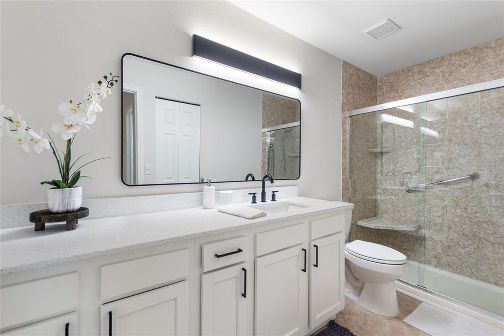 1950 Settlement Road, Unit 23 Venice, FL 34285 - Photo 17 of 33 a bathroom with a sink a toilet and a mirror