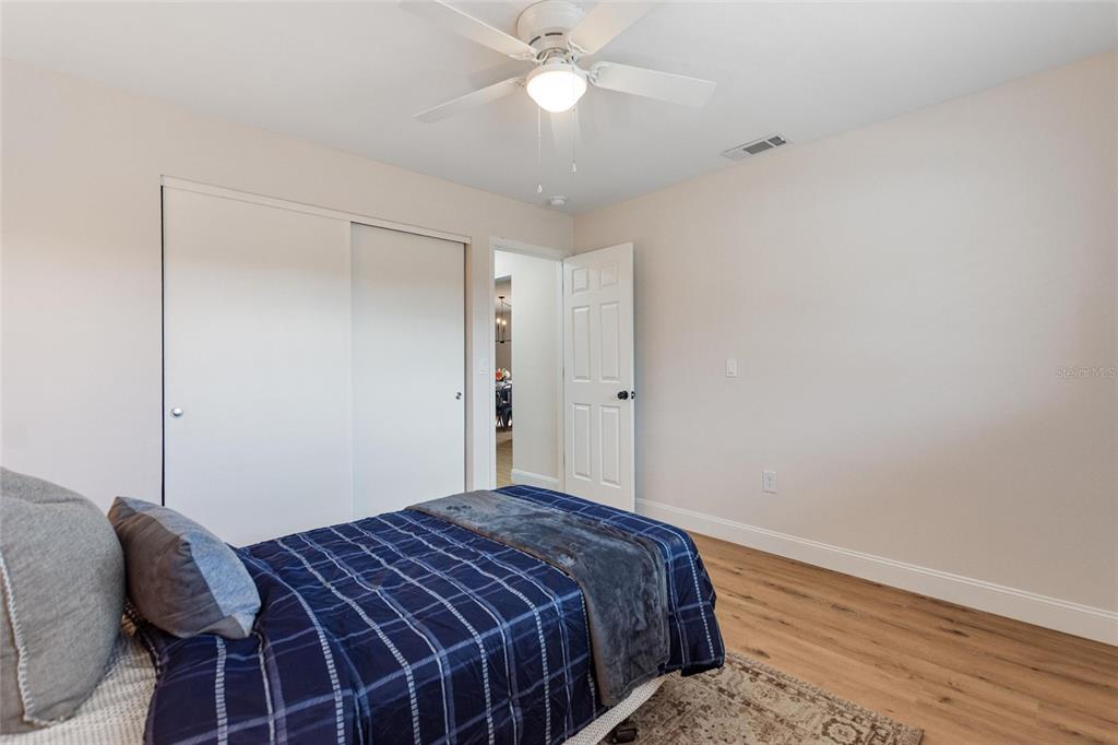 1950 Settlement Road, Unit 23 Venice, FL 34285 - Photo 20 of 33 a bedroom with a bed and a chandelier