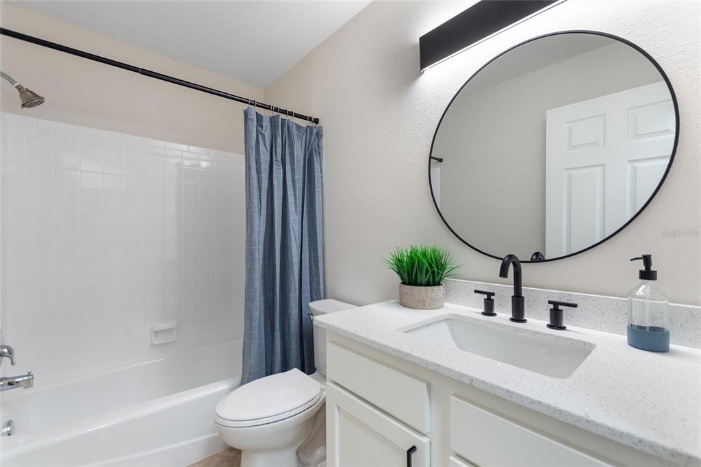 1950 Settlement Road, Unit 23 Venice, FL 34285 - Photo 21 of 33 a bathroom with a sink a toilet and a mirror