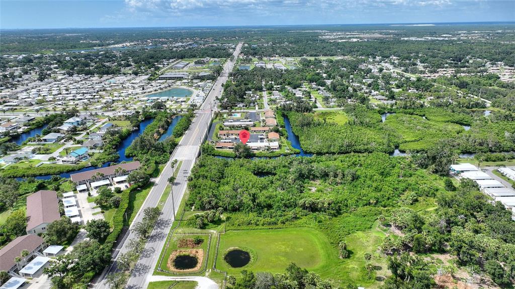 1950 Settlement Road, Unit 23 Venice, FL 34285 - Photo 28 of 33 an aerial view of residential houses with outdoor space and trees