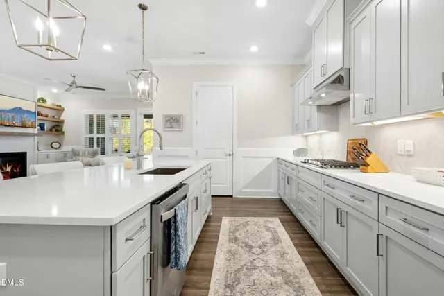 a kitchen with counter top space sink stove and cabinets