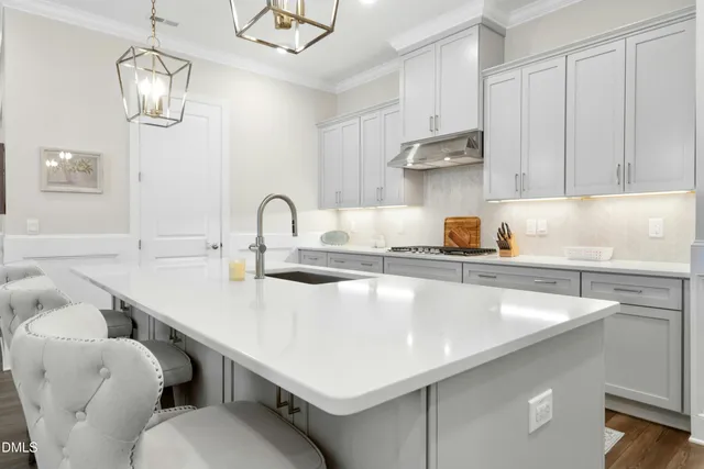 a kitchen with stainless steel appliances granite countertop a sink a stove and cabinets