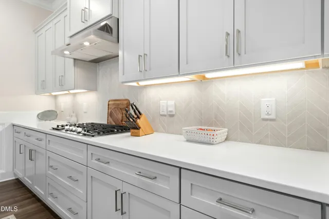 a kitchen with white cabinets and a stove