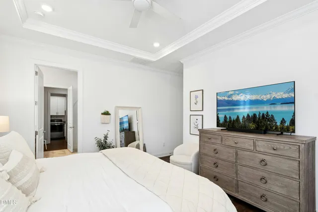 a bedroom with a bed and a large mirror on dresser