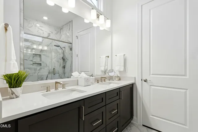 a bathroom with a double vanity sink and a mirror