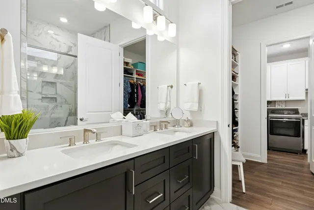 a view of walk in closet with clothes and shoes