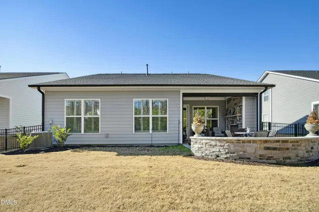 an aerial view of a multi story residential apartment building with backyard